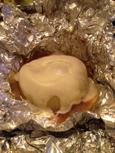 Throw some Swiss cheese on top. Loosely close the foil to hold in the heat and melt the cheese.