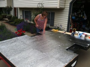 Attaching the silver bubble wrap insulation.